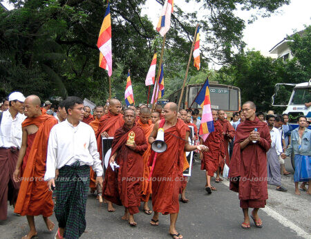 A group of monks leading pro-democracy marches through the streets