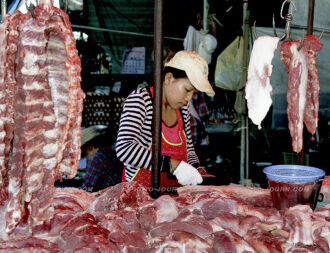 A butcher at work at the Klong Toei Market in Bangkok