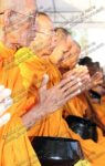 Monks accept alms from and give blessings to the red-shirts