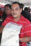 UDD co-leader Natthawut Saikua displays a bag of spoiled rice being provided to Thailand's rural poor by the Thai government