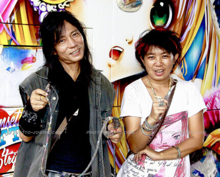 Toan Taveesabchai and assistant Suai show the tools they use to decorate Thailand tourist coaches