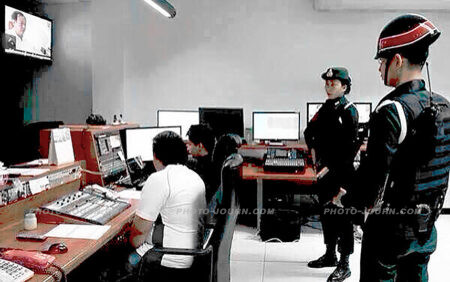 Thai army soldiers monitor what is broadcast in a TV station control room
