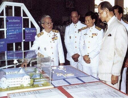 The late Thai  The late Thai King Bhumibol Adulyadej (r) is shown a model of the Wang Klai Kangwon School by the late grand chamberlain, Khwankeo Vajarodaya during the DLF inauguration