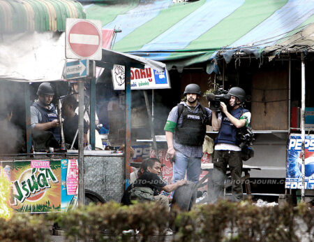 Well protected: A BBC team covering the Thailand political unrest on May 16, 2010