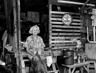 Too old to forage: this 103-year-old woman sits in front of her shantytown home relying on the kindness of others for meals and personal needs
