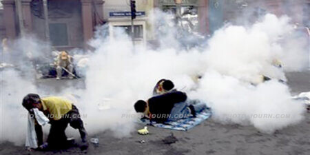 Anti-government protesters duck exploding teargas canisters in front of Parliament House in Bangkok, on Oct. 7, 2008