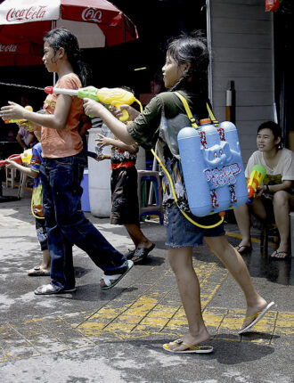 Armed, dangerous and on the prowl . Reserve fuel in this girls backpack means less downtime rearming- Songkran in Bangkok