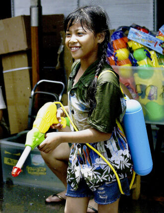 Armed, dangerous and on the prowl . Reserve fuel in this girls backpack means less downtime rearming- Songkran in Bangkok