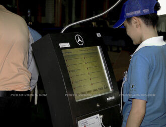 A worker interrogates an information kiosk on the Mercedes-Benz assembly line in Samut Prakan