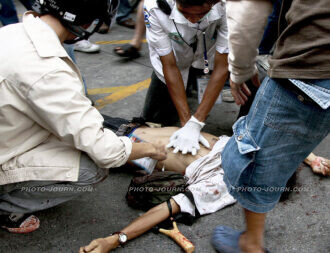 Medical teams work on a man shot dead by the Thai army under the Thailand Internal Security Act in 2010.